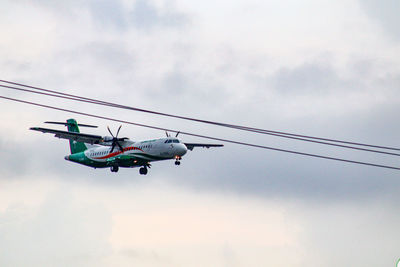 Low angle view of airplane against sky