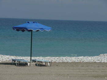 Parasol and lounge chairs at beach