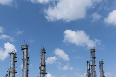 Low angle view of industrial buildings against sky