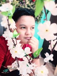 Portrait of cute girl with pink flowers