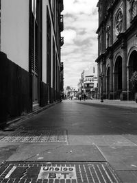 City street and buildings against sky