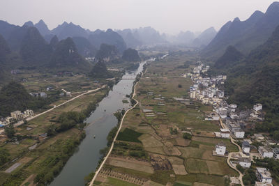 Aerial view of river and mountains against sky