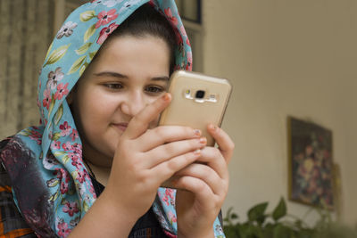 Portrait of woman photographing with mobile phone