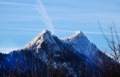 Low angle view of snowcapped mountain against sky