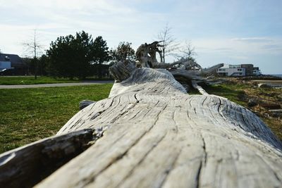 Old wooden structure on field against cloudy sky