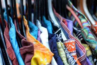 Close-up of clothes hanging in market for sale