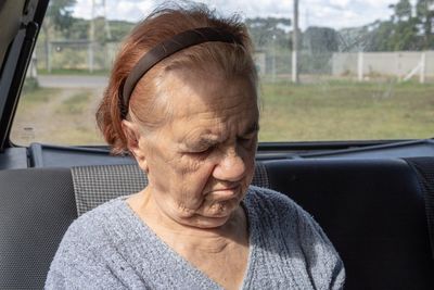 Senior woman sitting in car