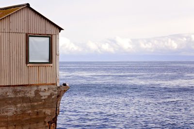 View of building by sea against sky