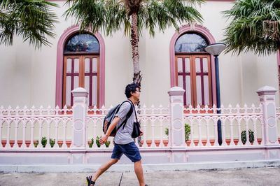 Full length of man standing by building