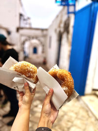 Cropped hand of person holding food