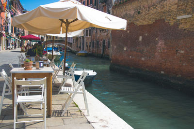 Chairs and tables at restaurant by sea