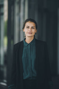 Portrait of confident businesswoman standing in city
