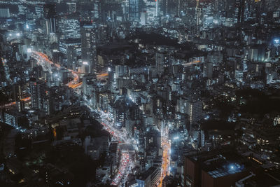 Aerial view of illuminated buildings in city at night