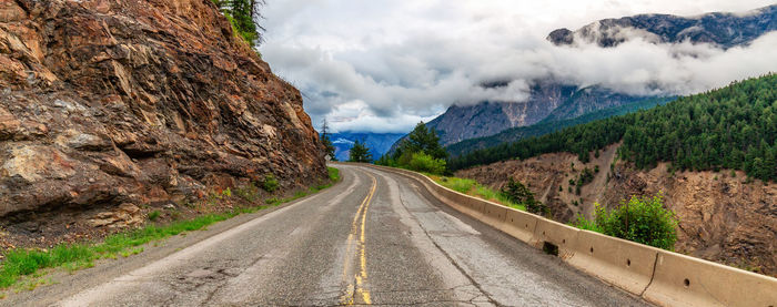 Road amidst mountains against sky