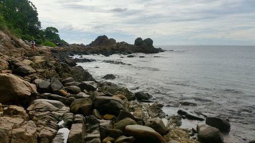 Rocks on beach against sky