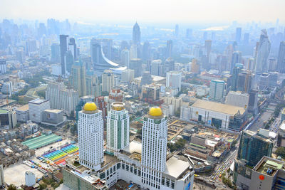 Aerial view of modern buildings in city against sky