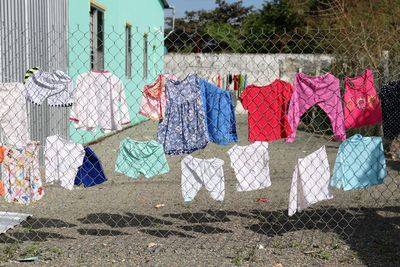 Clothes drying hanging on chainlink fence