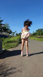 Full length of cute girl against sky