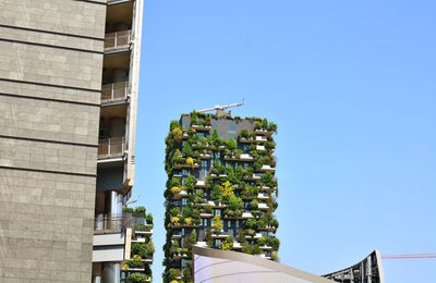 Low angle view of buildings against clear blue sky