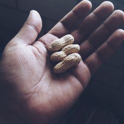 Close-up of hand holding peanuts