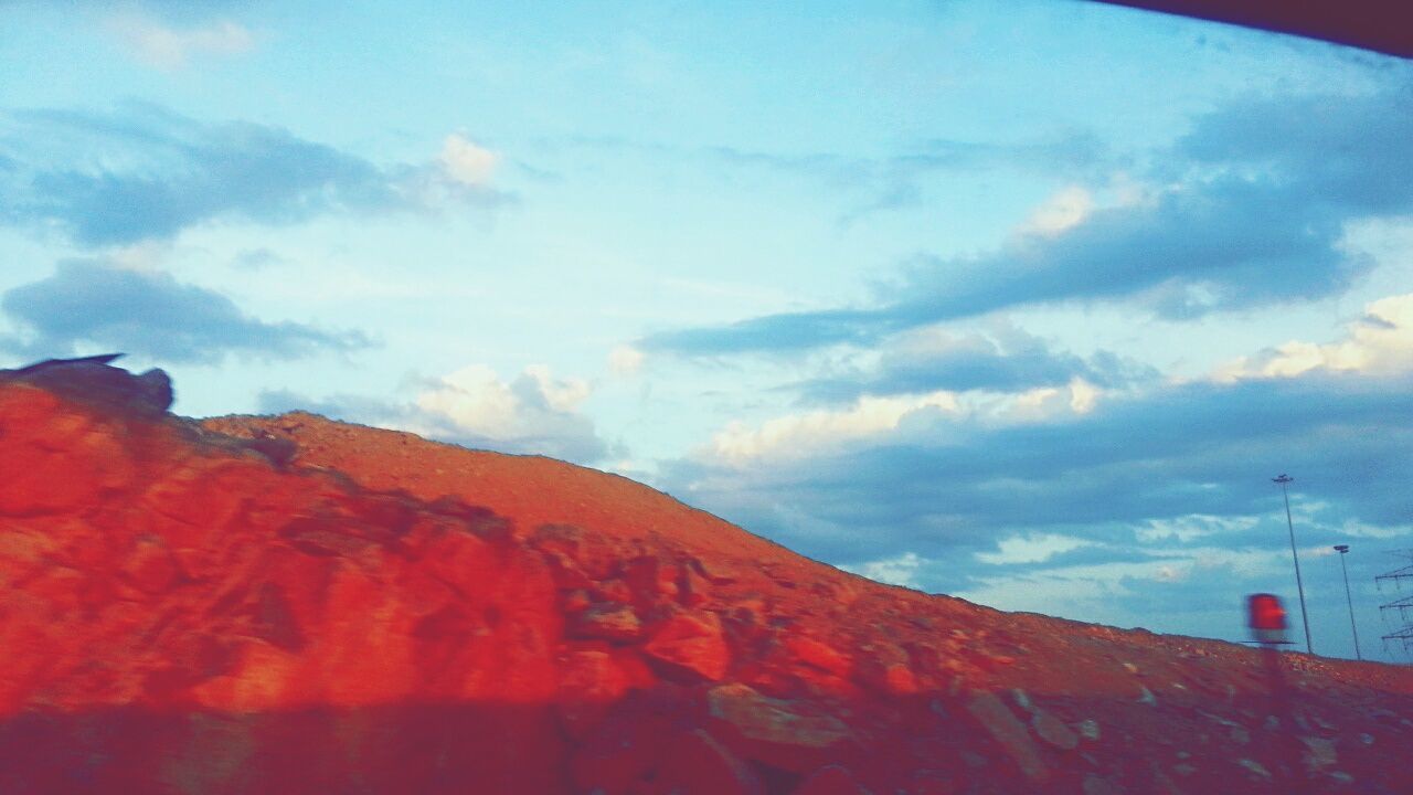 sky, cloud - sky, low angle view, cloudy, cloud, mountain, scenics, beauty in nature, tranquility, nature, blue, tranquil scene, outdoors, no people, day, weather, idyllic, landscape, red, non-urban scene