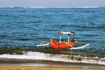 Boat in sea against sky