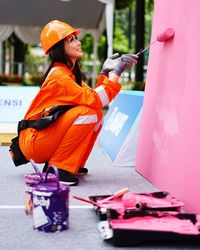 Side view of woman standing on umbrella