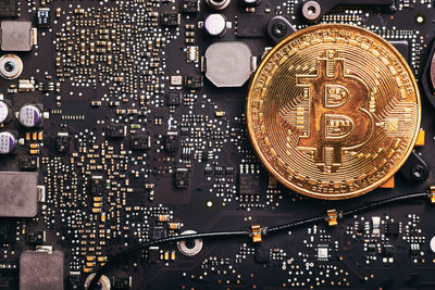 Close-up of bitcoin with computer equipment