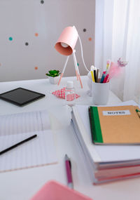 High angle view of laptop and book on table at home