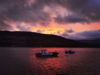 Scenic view of sea against dramatic sky during sunset in fort william