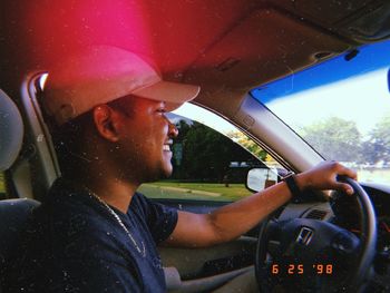 Portrait of young man in car