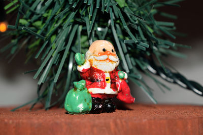 Close-up of figurine by christmas tree