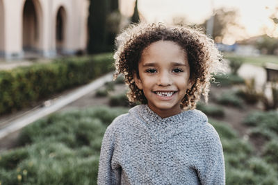 Portrait of smiling boy standing outdoors