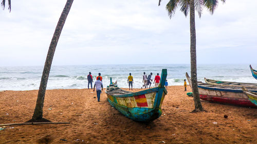 People on beach against sky