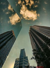 Low angle view of modern buildings against sky during sunset