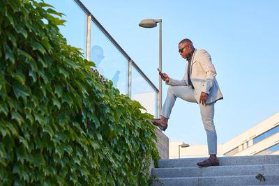 African american businessman with mobile phone on a summer afternoon.