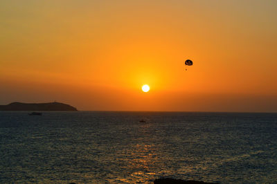 Scenic view of sea against orange sky