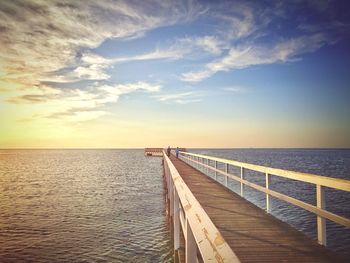 Jetty in sea against sky