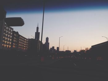 Buildings in city at sunset