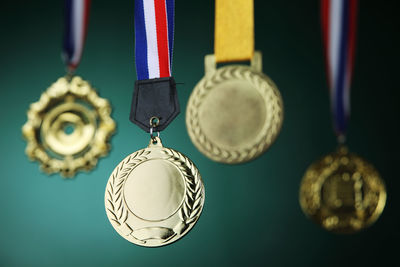 Close-up of gold medals against blackboard