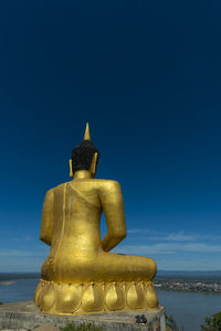 Statue against blue sky