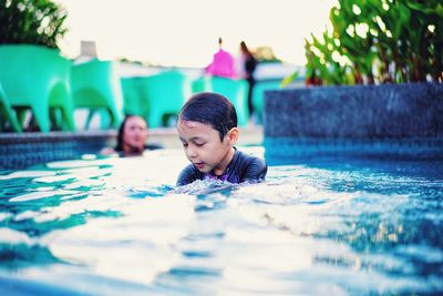 Boy swimming in pool