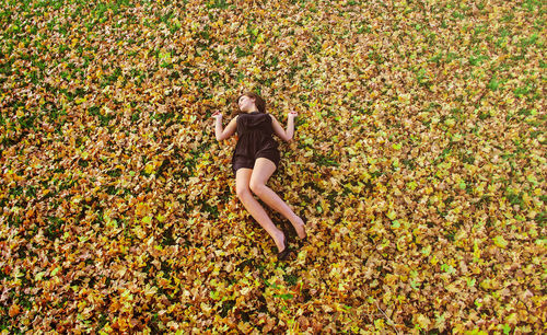 High angle view of woman lying on grass