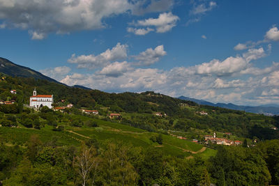 Scenic view of landscape and houses against sky