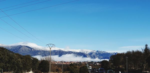 Scenic view of snowcapped mountains against blue sky