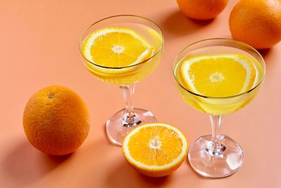 Various fruits on glass of orange juice