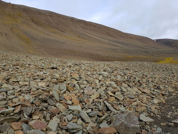 Scenic view of land and mountain against sky