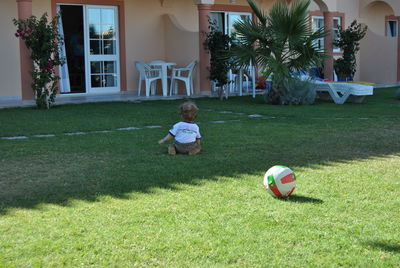 People playing soccer ball in yard