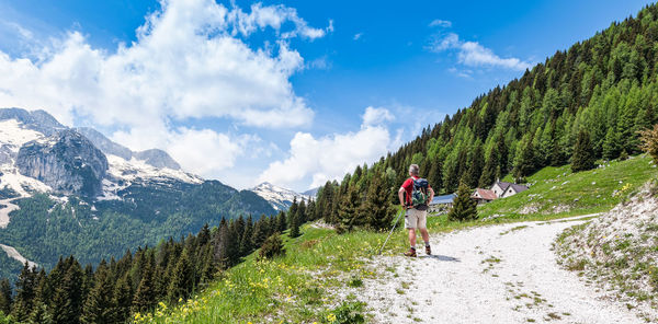 Rear view of people on mountain against sky