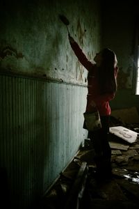 Full length of a young woman standing on tiled floor